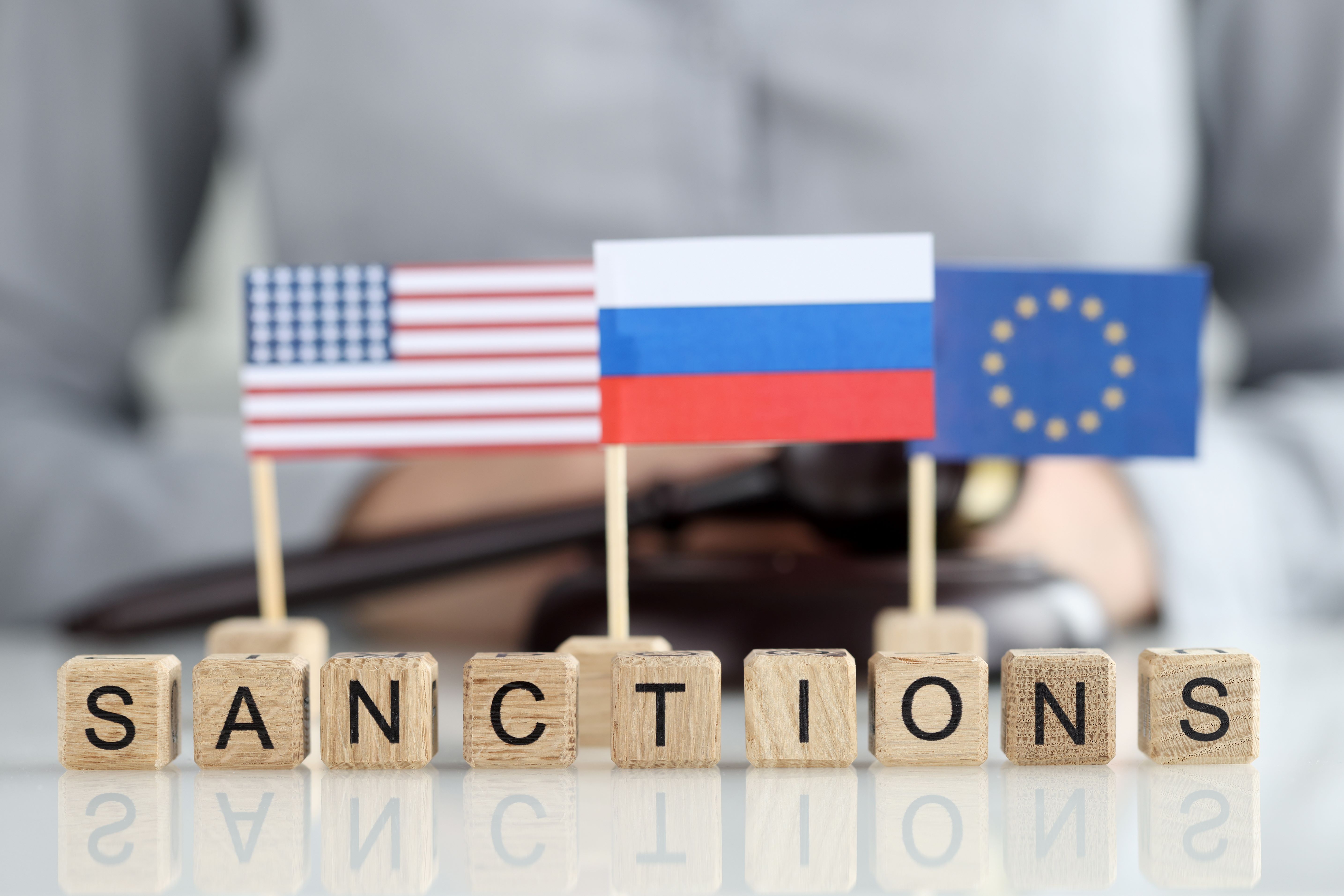 Sanction below flags: US, Russia and EU