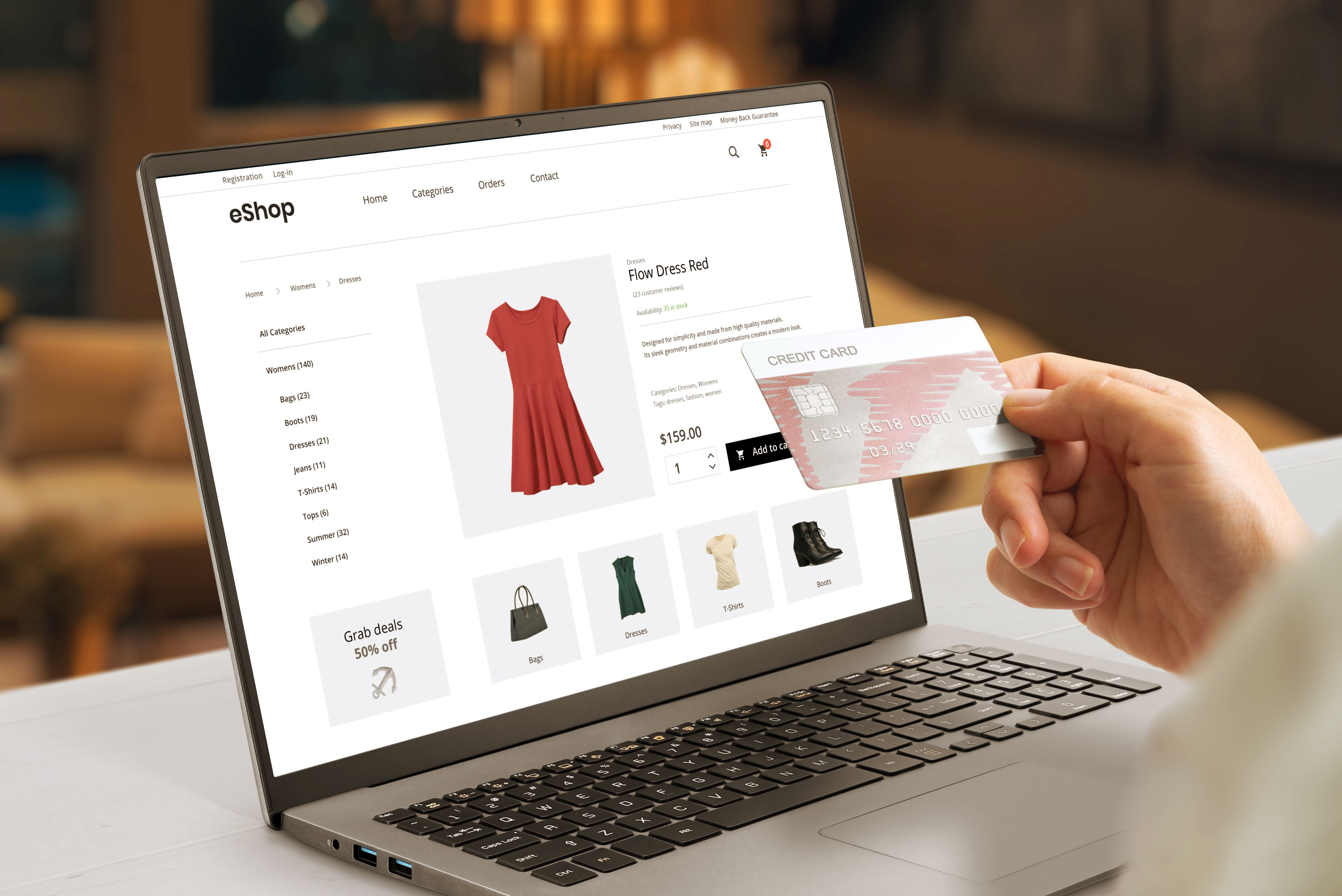 Shopper buying women's dress online, holding credit card