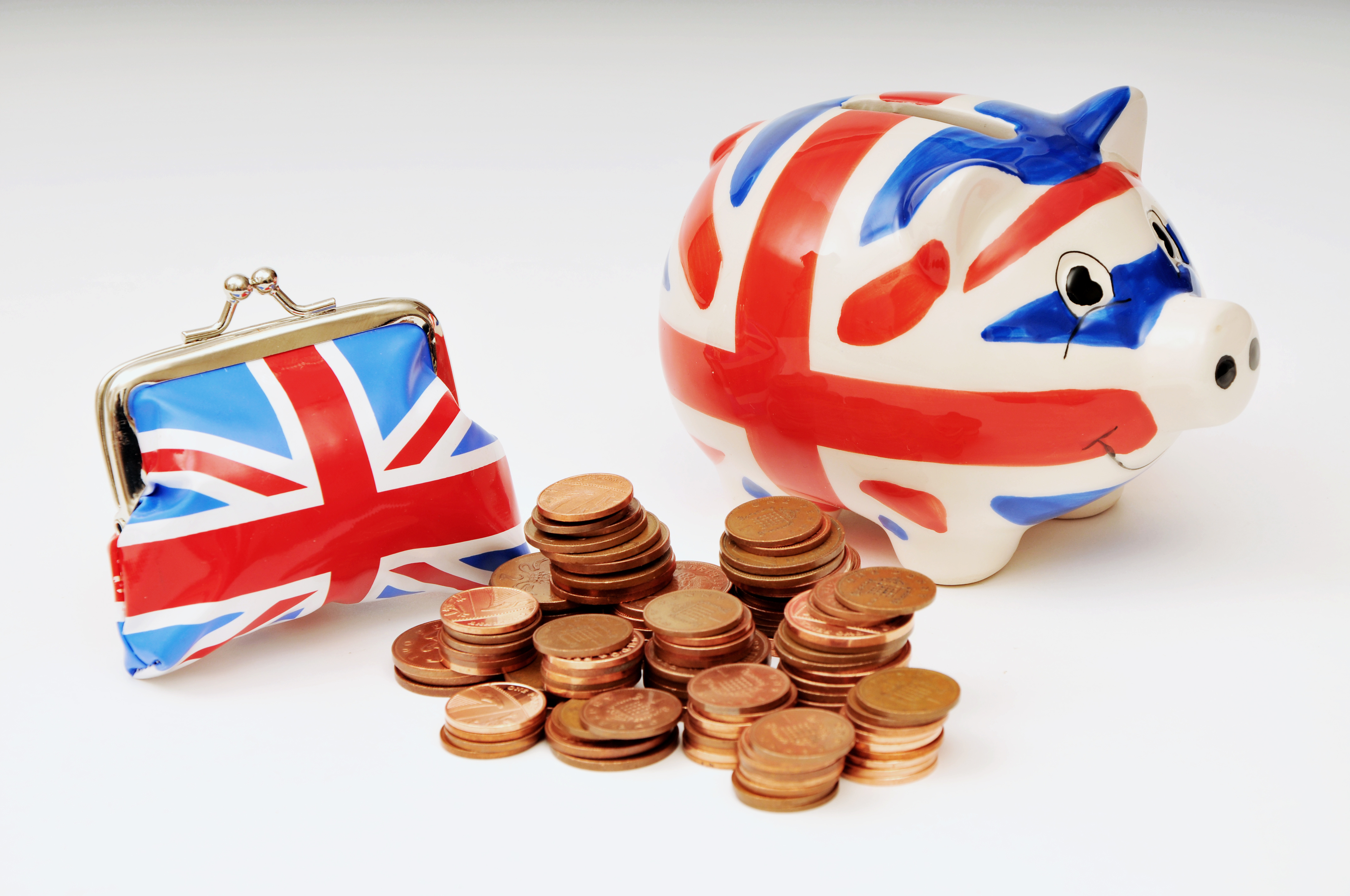 Piggy bank with UK flag surrounded by money