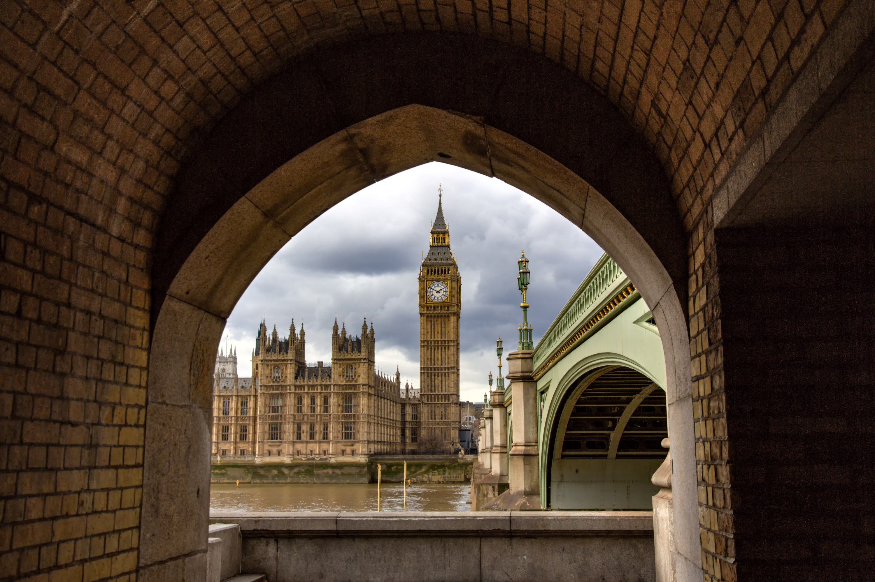 View of Parliament through an arch across the river