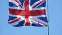 Union Jack flag flying against a blue sky